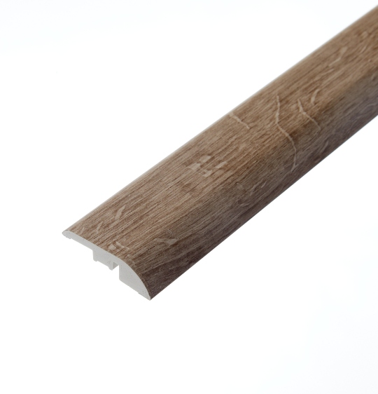 A detailed photograph of the Ezra Mink ramp profile. This flooring piece showcases a mink-toned finish with subtle wood grain patterns, designed to provide a smooth transition between different floor heights.